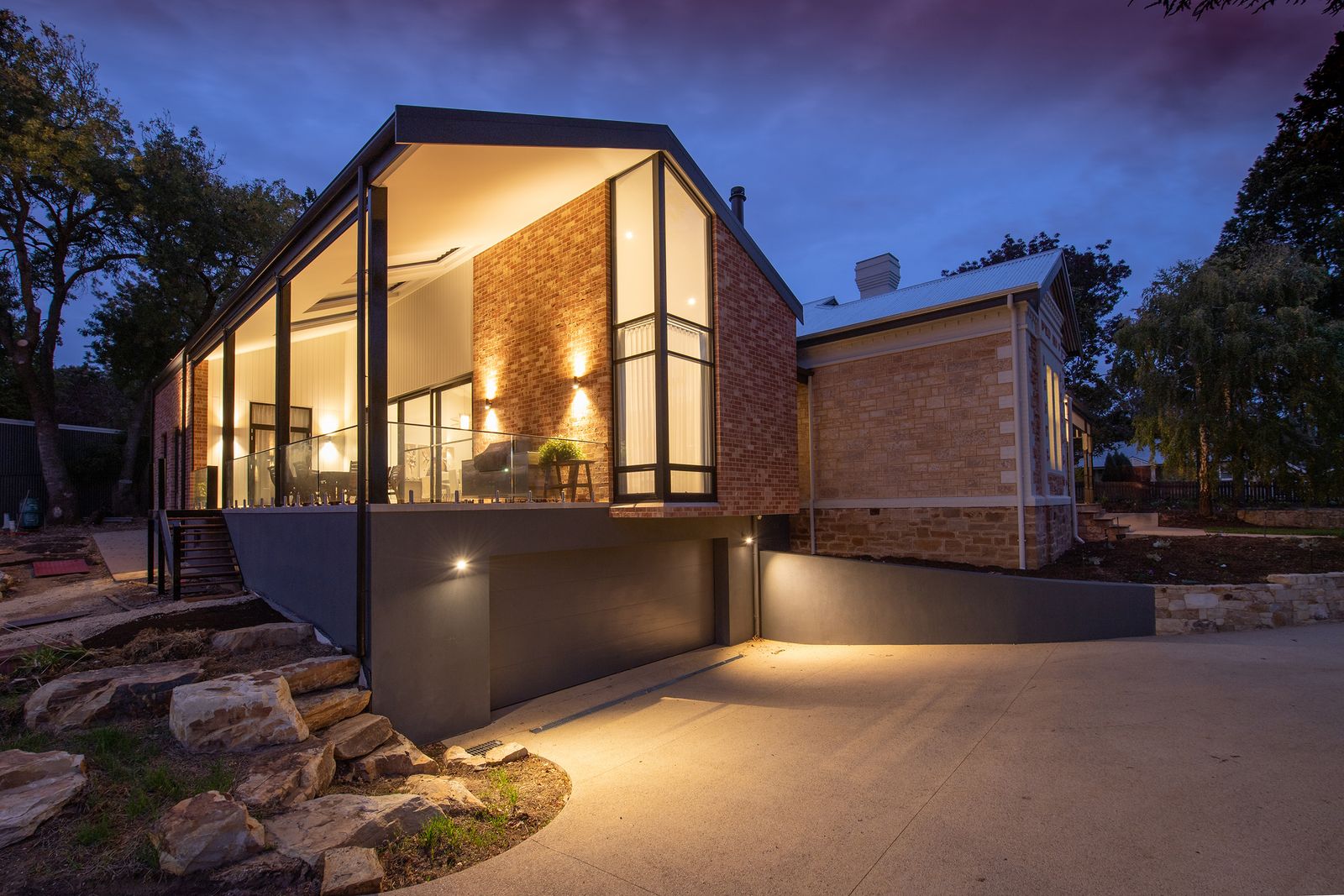 Sun-warmed UK family home at dawn: light cream stone, slate roof, garden wrapping the south side