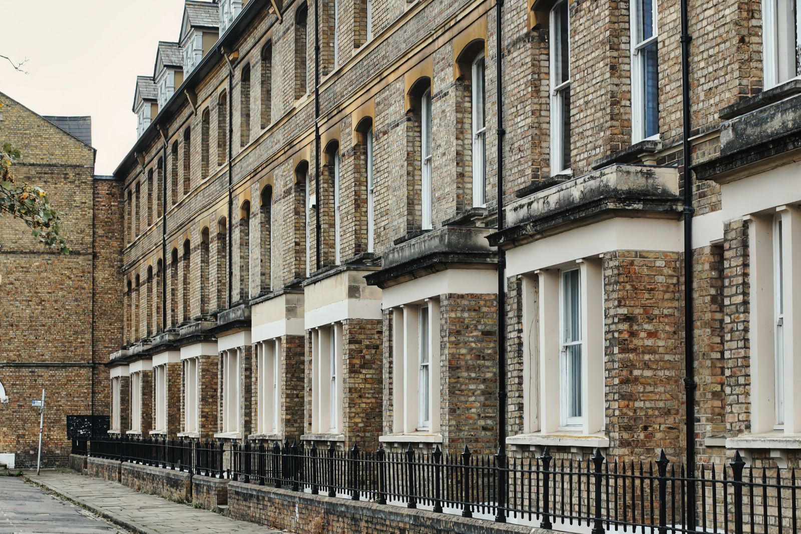 A row of UK Victorian terraced houses, typical social-housing stock