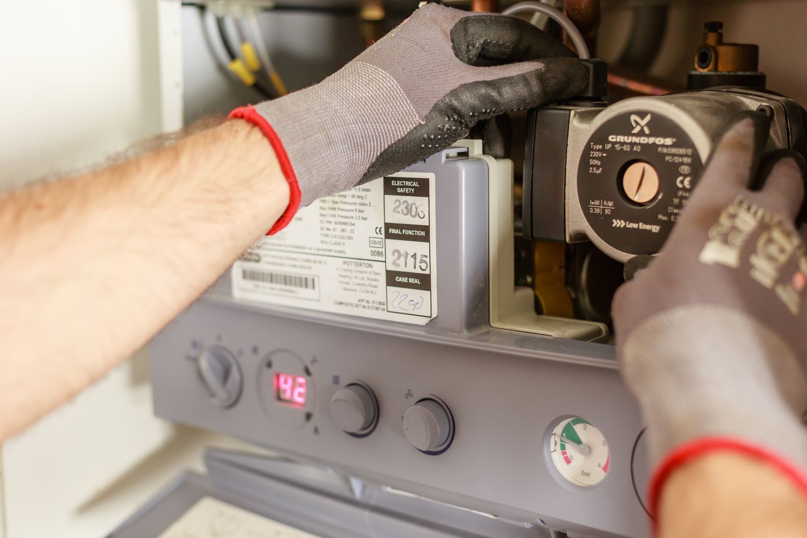 A Gas Safe engineer servicing a modern combi boiler