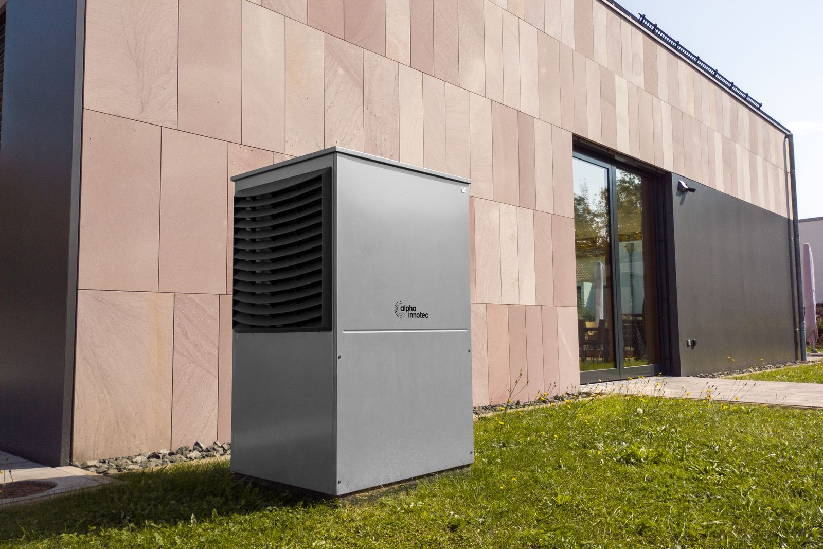 An air source heat pump installed beside a modern home